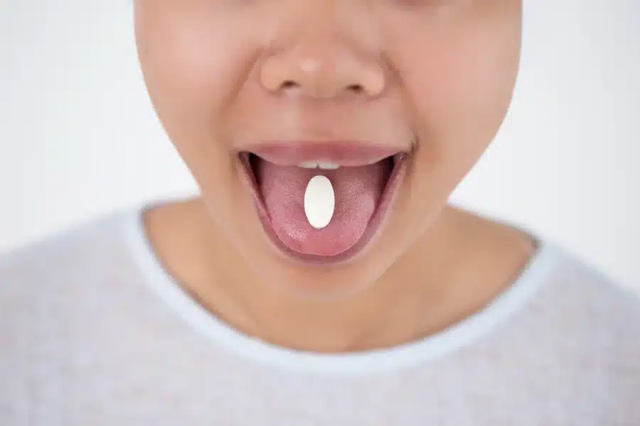 A person taking supplements that cause dry mouth