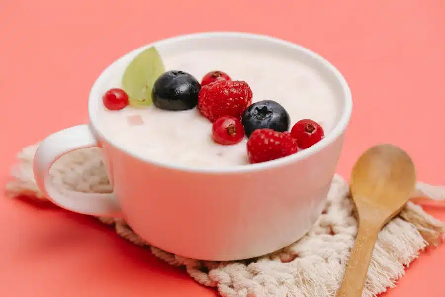 A bowl of yogurt and fruit to combat the dry mouth experienced from taking supplements
