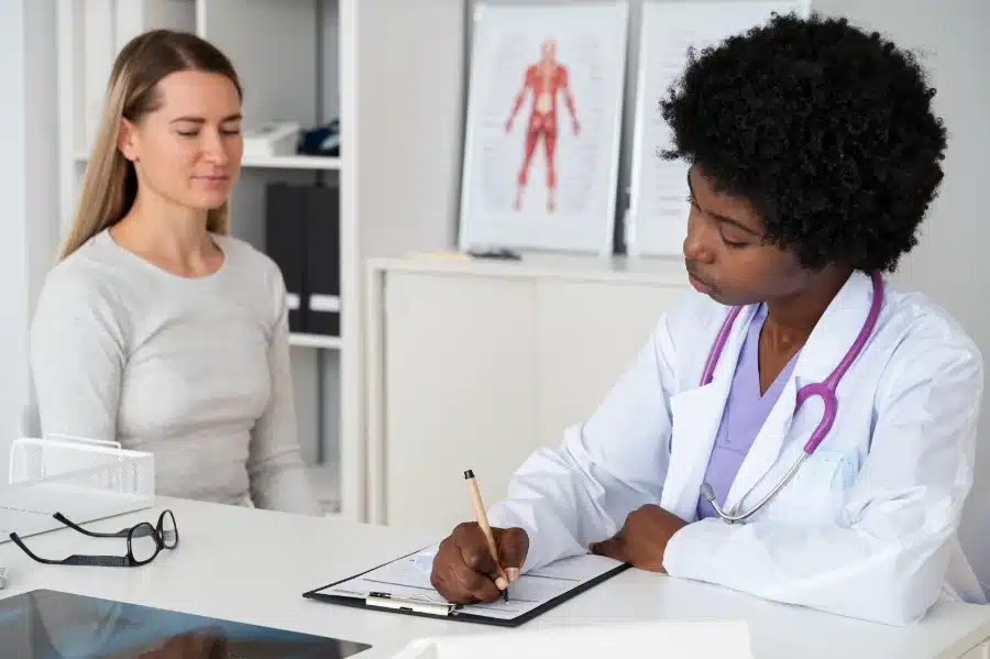 Alt Text: A woman talking to her doctor about the possible consequences of not switching to a paraben free and sulfate free lifestyle.