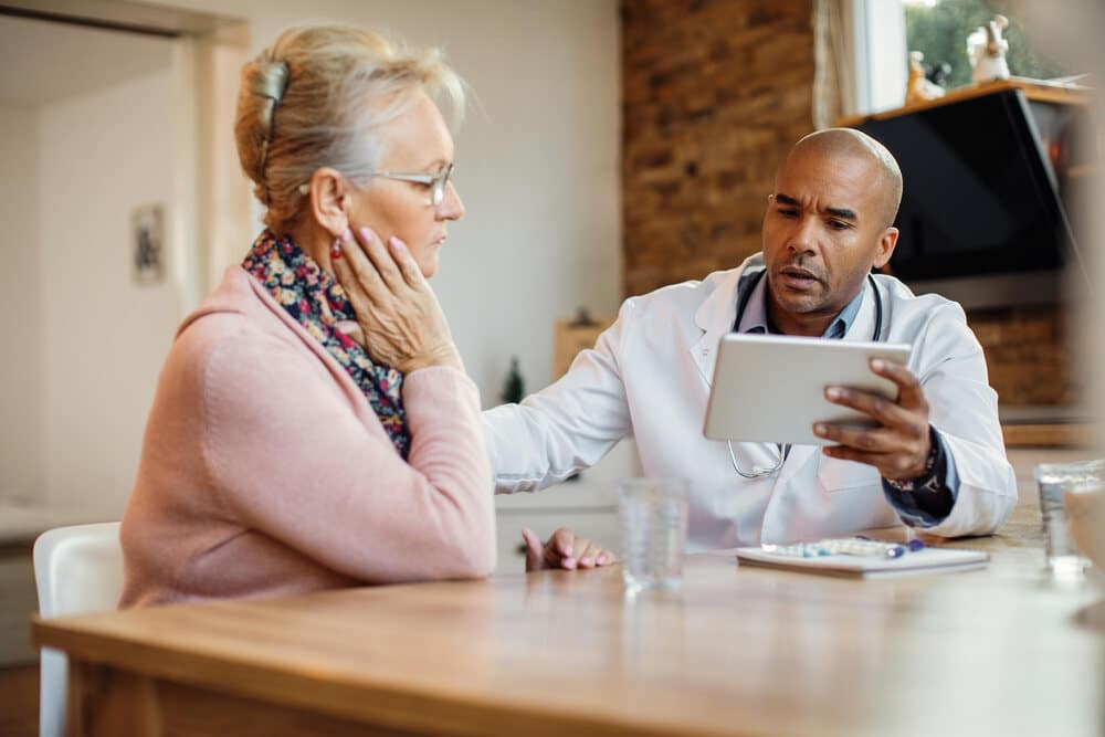 A woman talking to her doctor about the potential side effects of incorporating xylitol into her oral care routine.