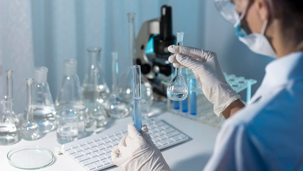 A scientist testing a formula with xylitol and hyaluronic acid to improve moisture retention solutions for soothing dry mouth symptoms.