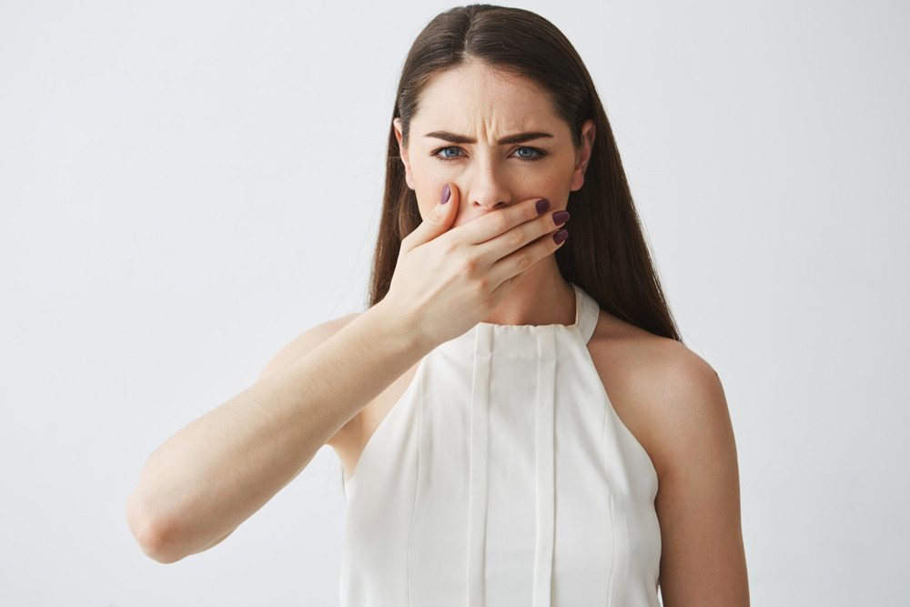 A woman with Burning Mouth Syndrome considering various dry mouth remedies.