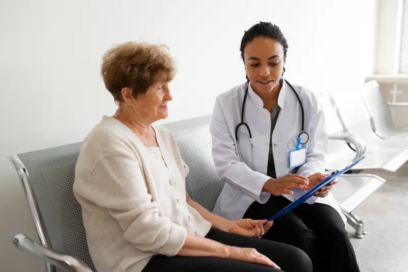 A doctor discussing strategies for managing polypharmacy induced dry mouth with an elderly patient.