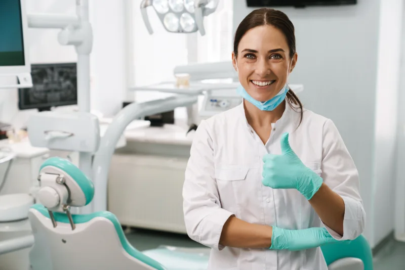 A dentist with her thumb up in support of sleep apnea patients using Lubricity Xtra to soothe CPAP dry mouth